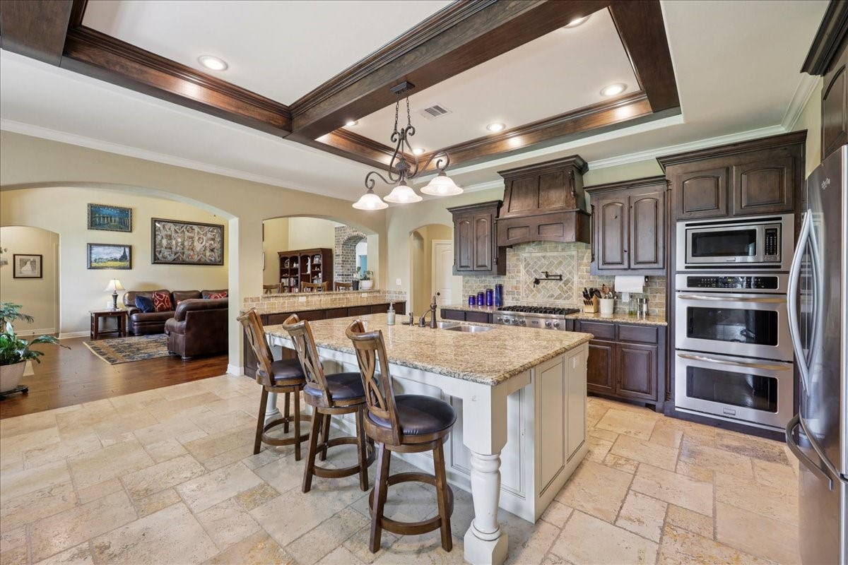 404 Birch View Drive Lumberton, TX 77657 - Photo 14 of 44 a kitchen with stainless steel appliances granite countertop table chairs sink and cabinets