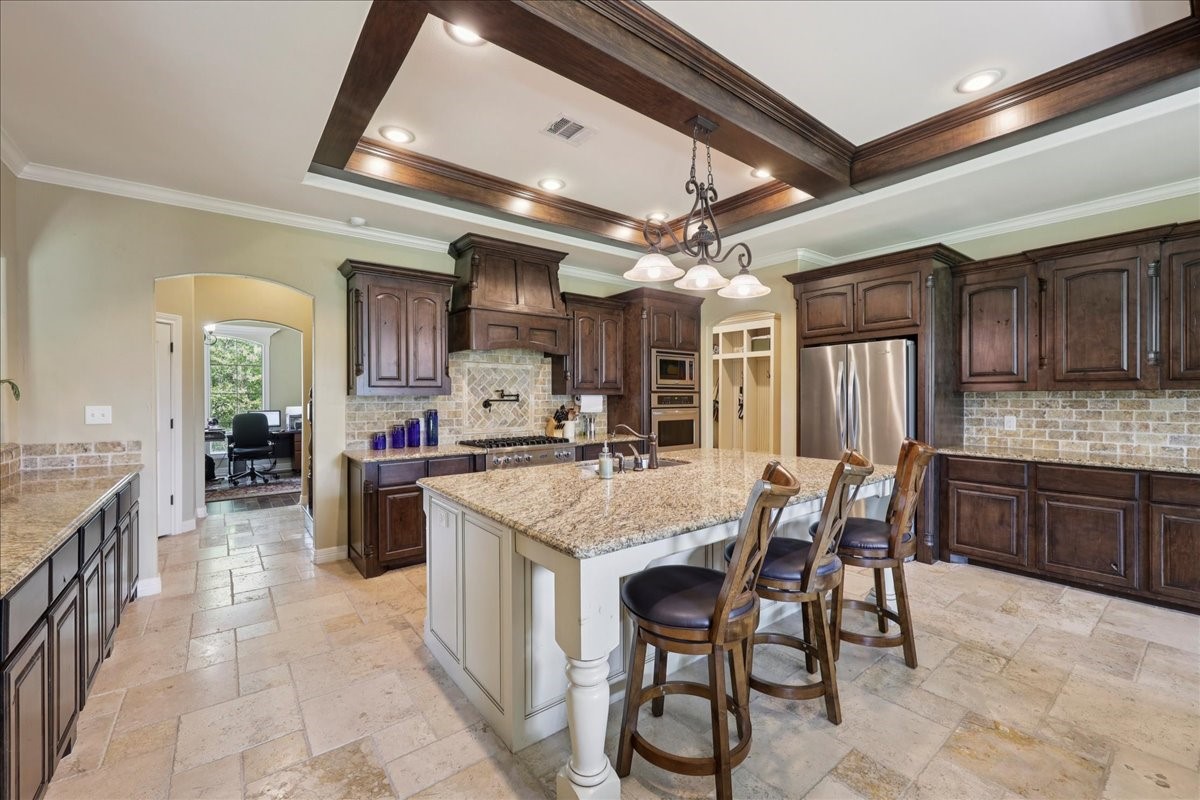 404 Birch View Drive Lumberton, TX 77657 - Photo 15 of 44 a kitchen with stainless steel appliances kitchen island granite countertop a table chairs and a refrigerator