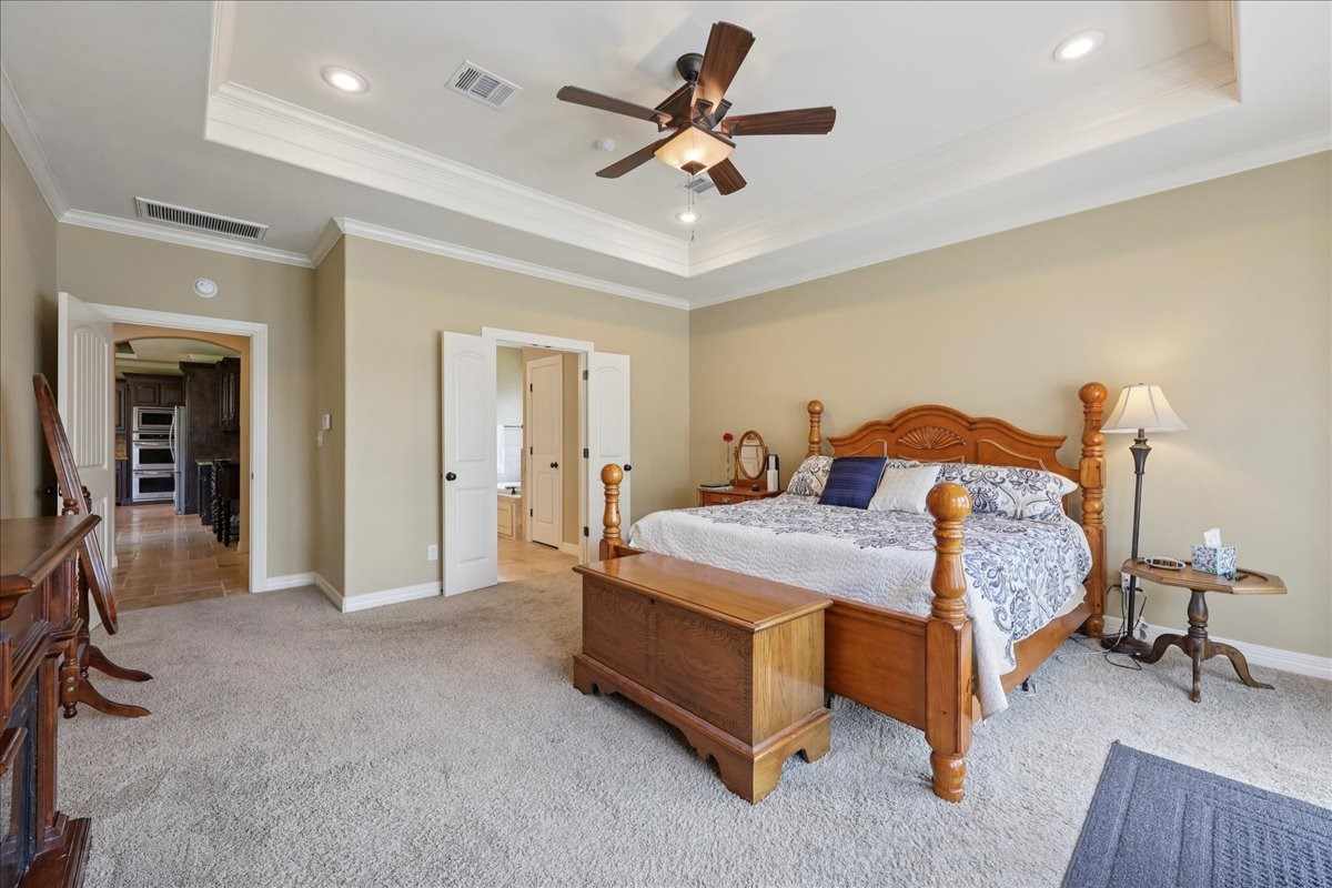 404 Birch View Drive Lumberton, TX 77657 - Photo 19 of 44 a bedroom with a bed and a chandelier