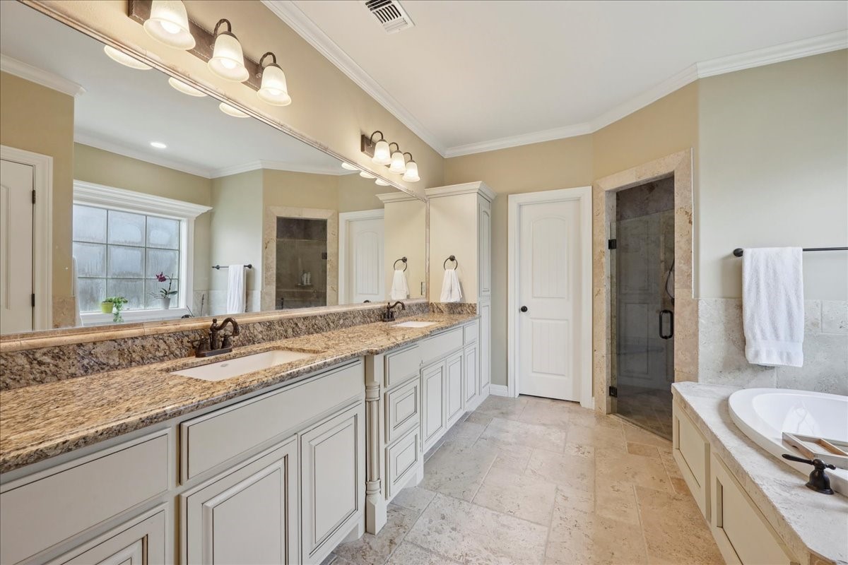 404 Birch View Drive Lumberton, TX 77657 - Photo 21 of 44 a spacious bathroom with a granite countertop double vanity sink a mirror and a bathtub