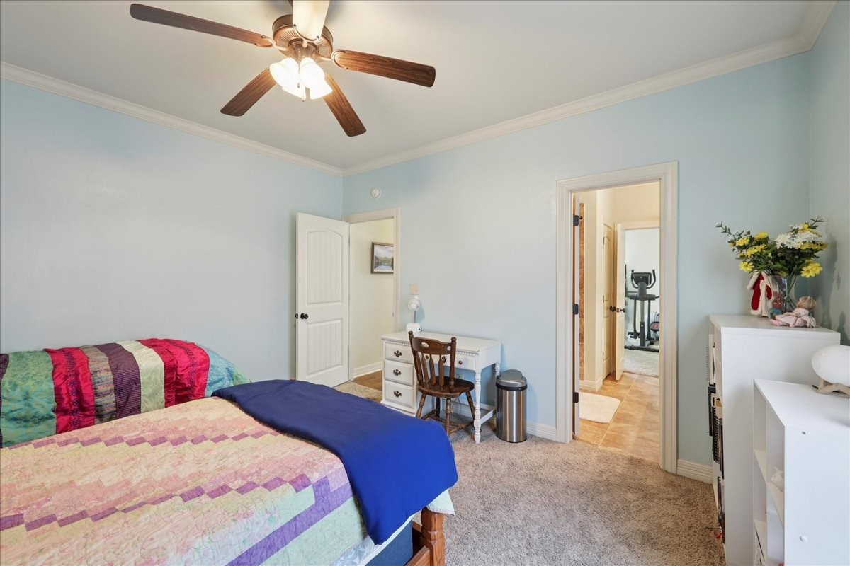 404 Birch View Drive Lumberton, TX 77657 - Photo 27 of 44 a bedroom with a bed and a chandelier