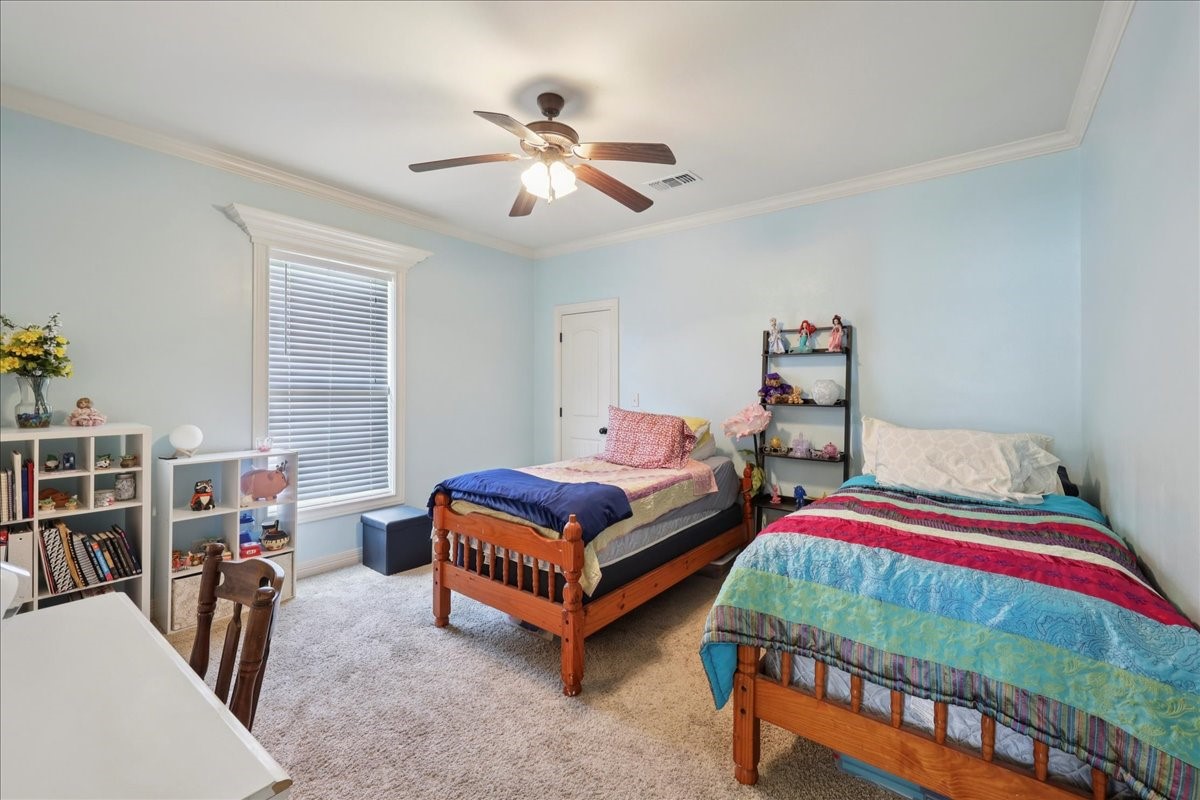 404 Birch View Drive Lumberton, TX 77657 - Photo 28 of 44 a bedroom with 2 bed and a chandelier