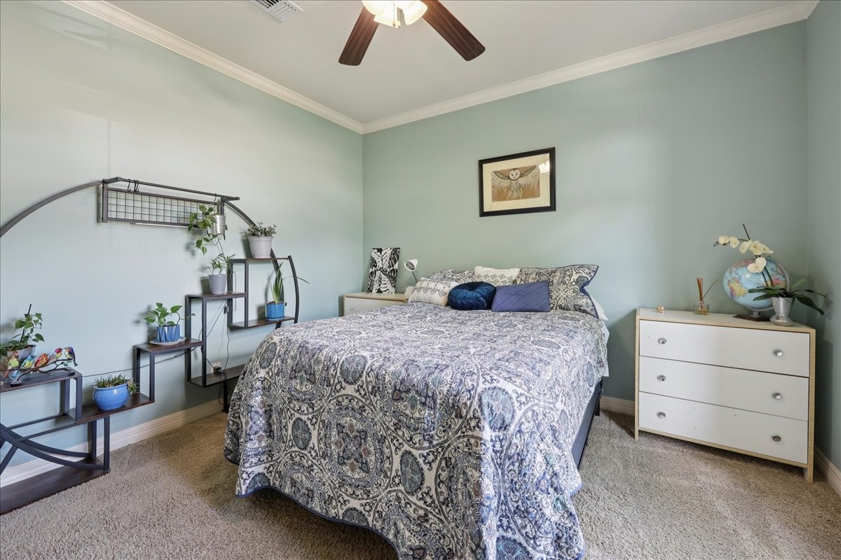 404 Birch View Drive Lumberton, TX 77657 - Photo 30 of 44 a bedroom with a bed a chandelier and a dresser