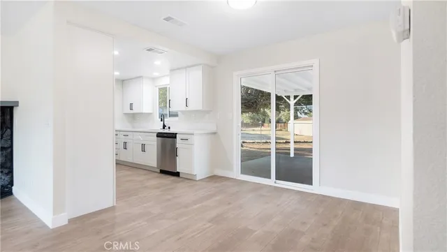 a view of a kitchen with large windows
