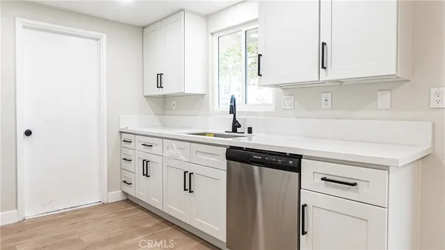 a kitchen with granite countertop white cabinets and white appliances