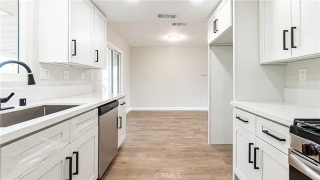 a kitchen with granite countertop a sink and cabinets