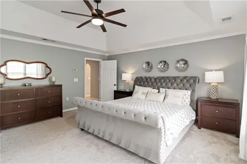 a bedroom with a bed and a chandelier