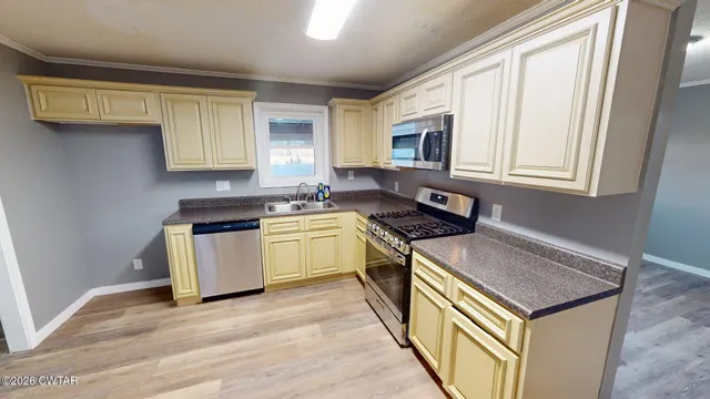 a kitchen that has a sink and a stove top oven