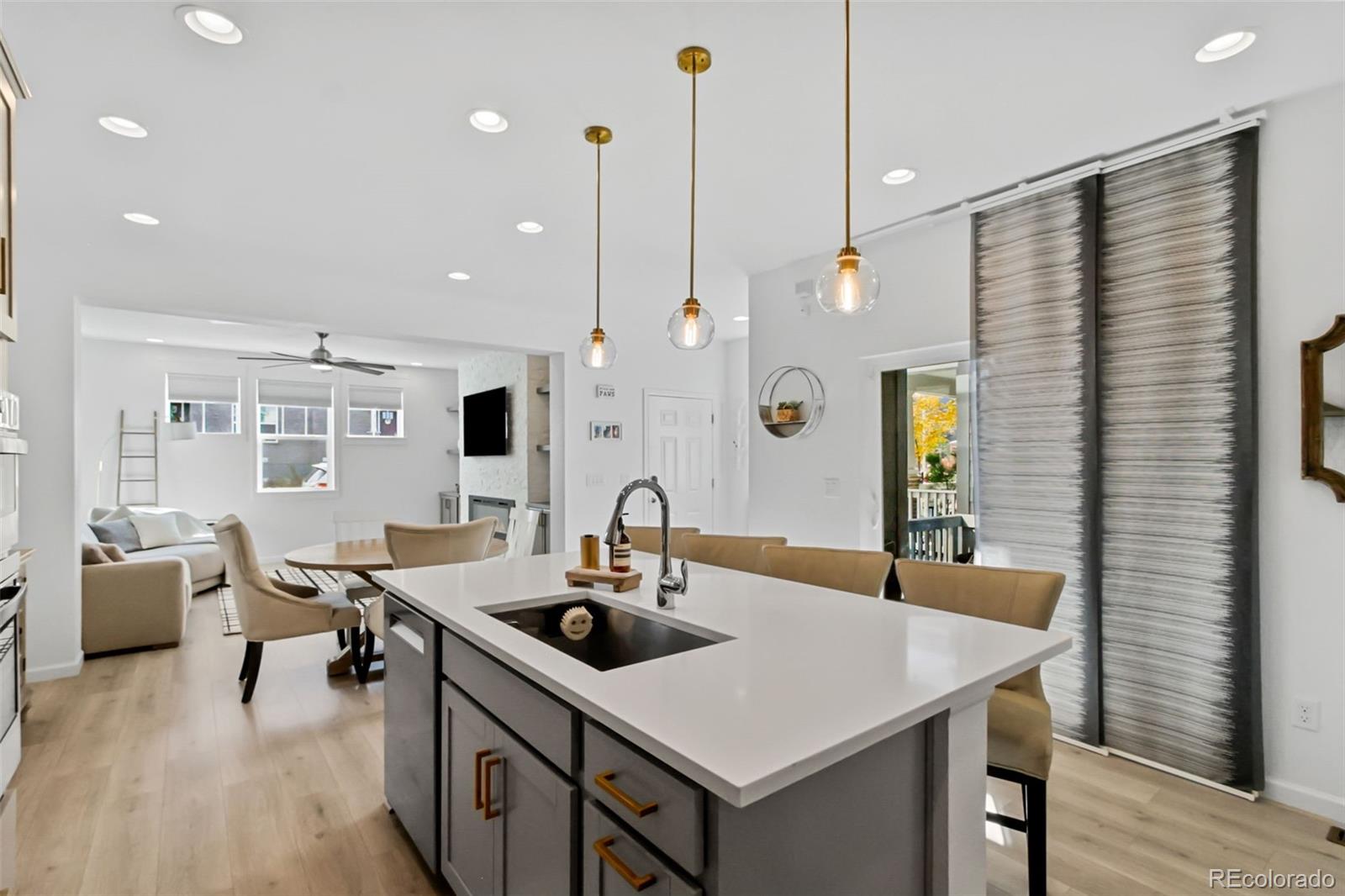 9753 Middle Peak Street Littleton, CO 80125 - Photo 11 of 41 a kitchen with a table chairs and wooden floor