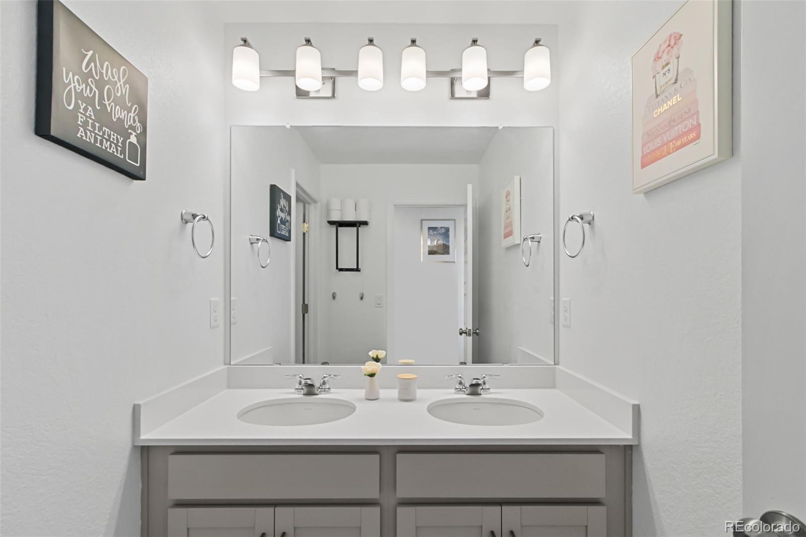 9753 Middle Peak Street Littleton, CO 80125 - Photo 21 of 41 a bathroom with a sink and a mirror