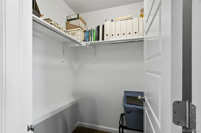 a front view of a house with a yard and potted plants