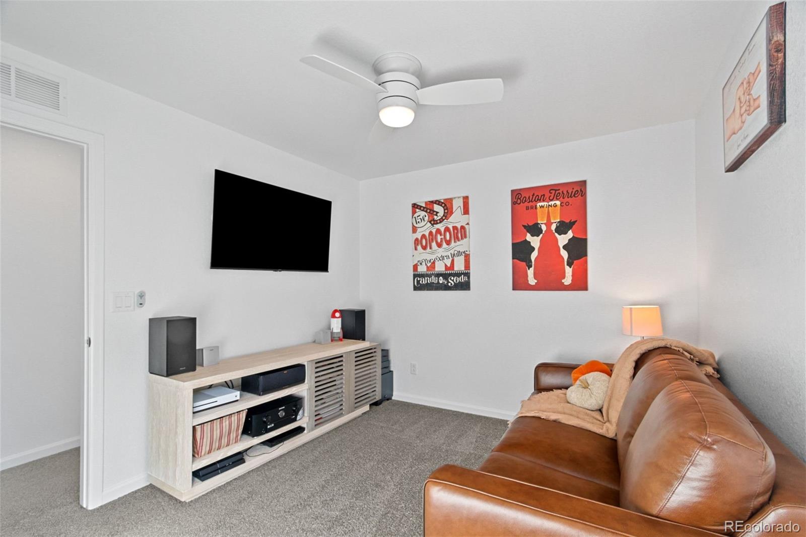 9753 Middle Peak Street Littleton, CO 80125 - Photo 25 of 41 a living room with furniture and a flat screen tv