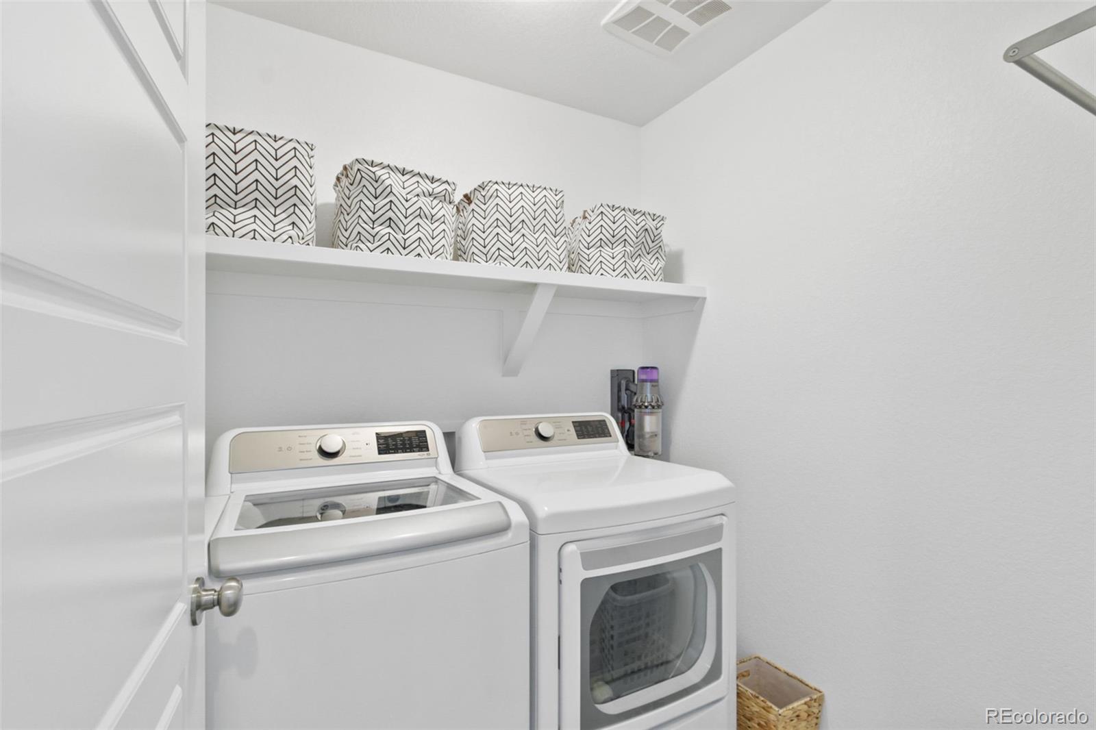 9753 Middle Peak Street Littleton, CO 80125 - Photo 27 of 41 a utility room with dryer and washer