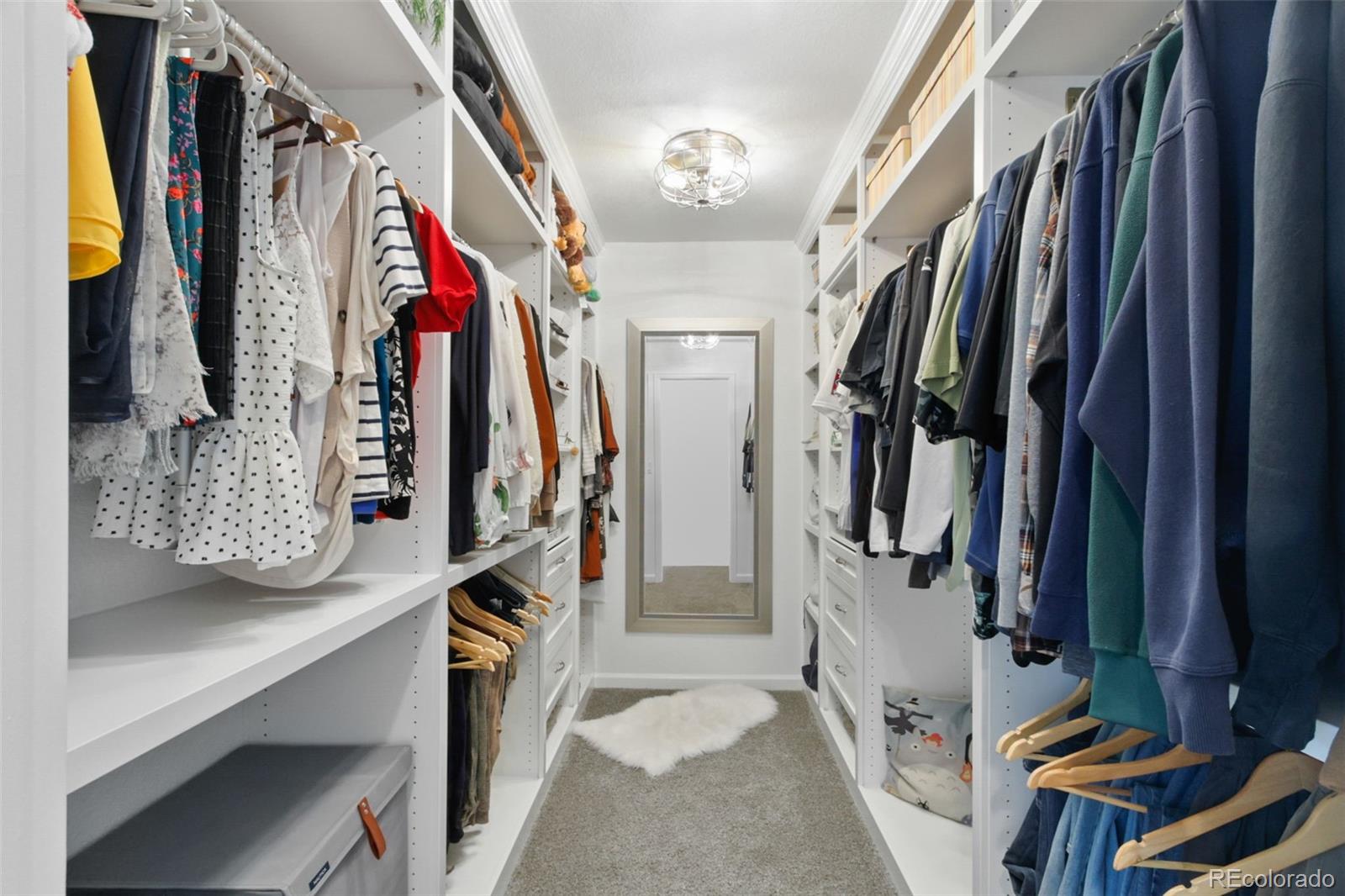 9753 Middle Peak Street Littleton, CO 80125 - Photo 32 of 41 a view of walk in closet with clothes and shoes
