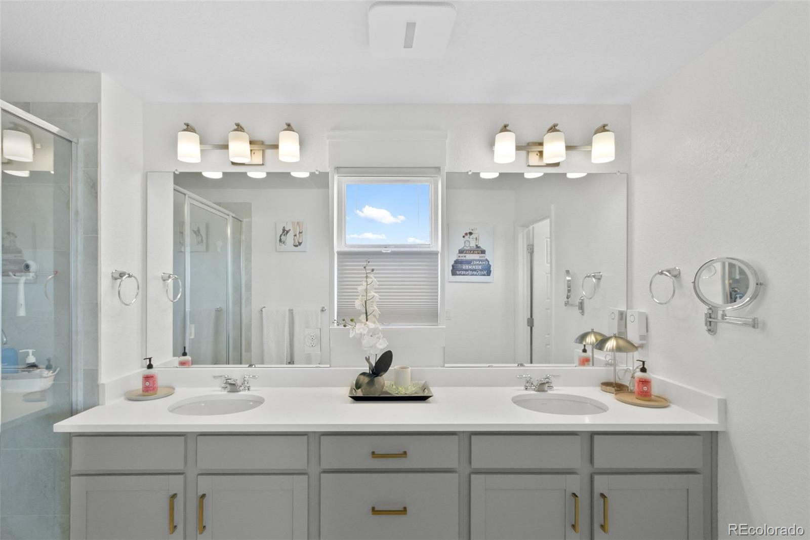 9753 Middle Peak Street Littleton, CO 80125 - Photo 33 of 41 a bathroom with a sink double vanity and a mirror