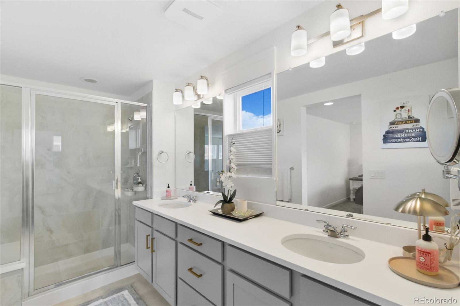 9753 Middle Peak Street Littleton, CO 80125 - Photo 34 of 41 a bathroom with a double vanity sink mirror and shower