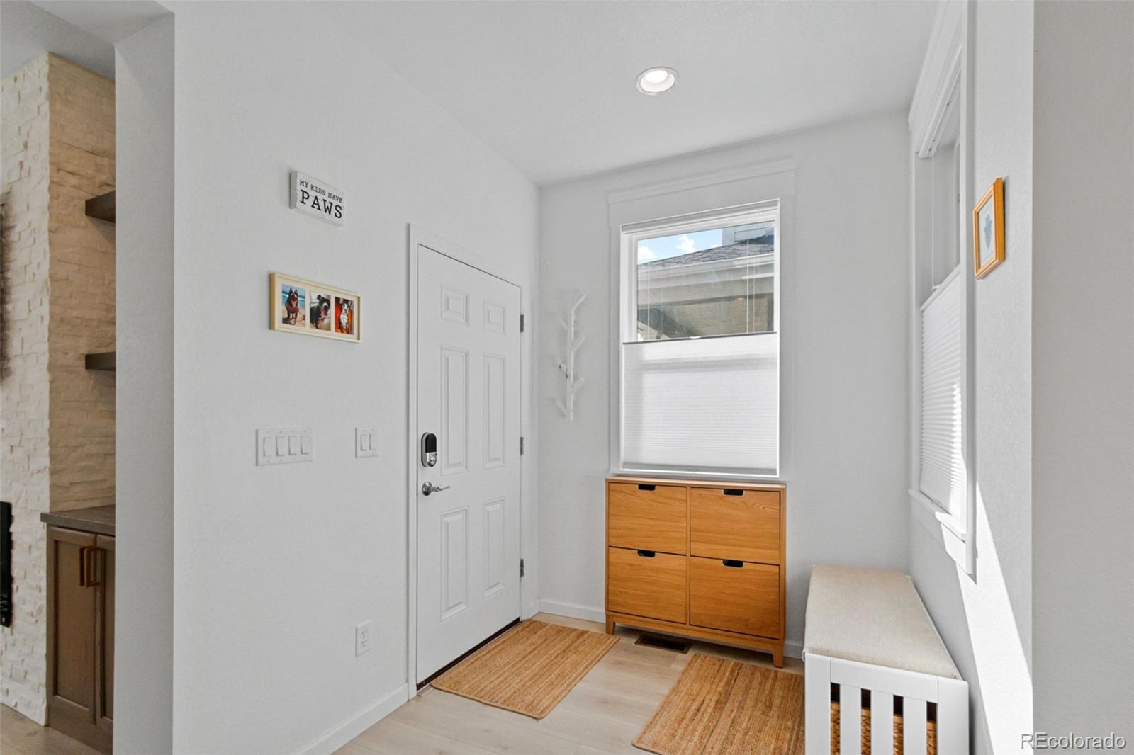 9753 Middle Peak Street Littleton, CO 80125 - Photo 4 of 41 a view of hallway with wooden floor