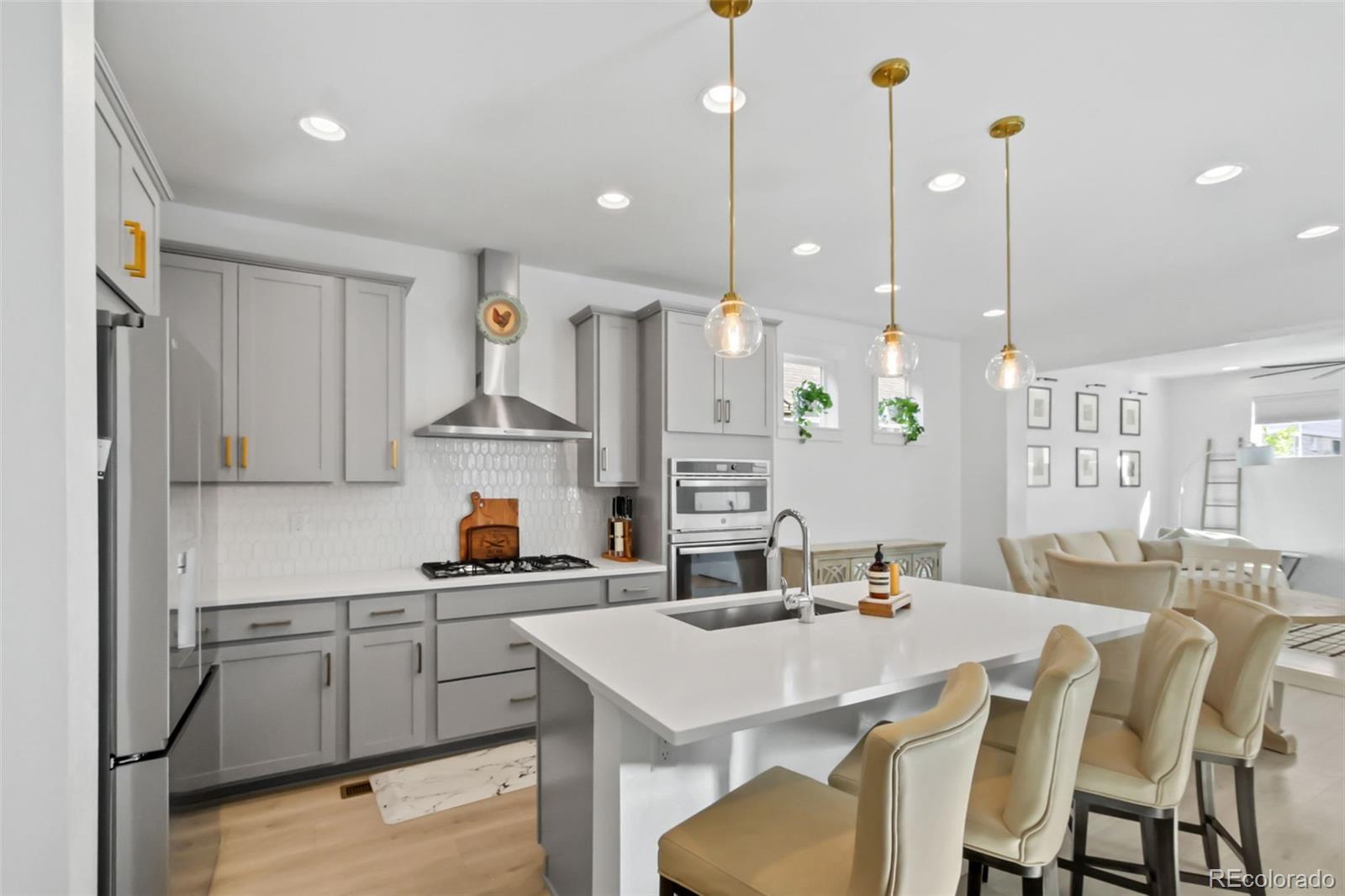 9753 Middle Peak Street Littleton, CO 80125 - Photo 10 of 41 a kitchen with kitchen island a stove a table and chairs