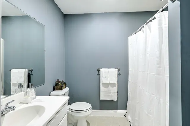 a white toilet sitting next to a bathroom sink