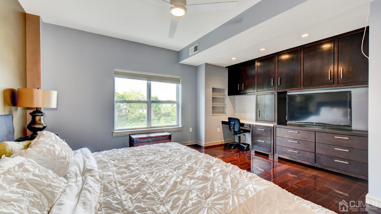 358 Rector Street, Unit 404 Perth Amboy, NJ 08861 - Photo 15 of 26 a bedroom with a bed and a flat screen tv
