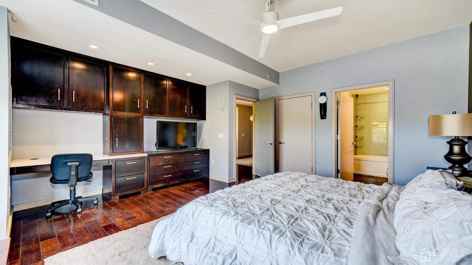 358 Rector Street, Unit 404 Perth Amboy, NJ 08861 - Photo 17 of 26 a bedroom with a bed and furniture with kitchen view