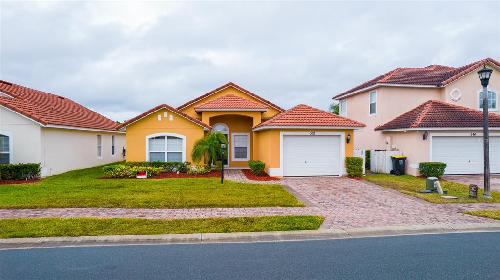 a front view of a house with a yard and garage