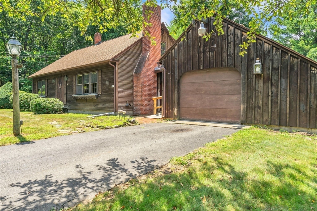 34 Crest Road Monson, MA 01057 - Photo 36 of 42 a view of yellow house with a small yard and wooden fence