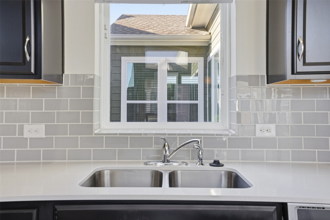 12604 Red Sparrow Street, Unit 14 Austin, TX 78729 - Photo 25 of 40 Kitchen featuring tasteful backsplash and light stone countertops