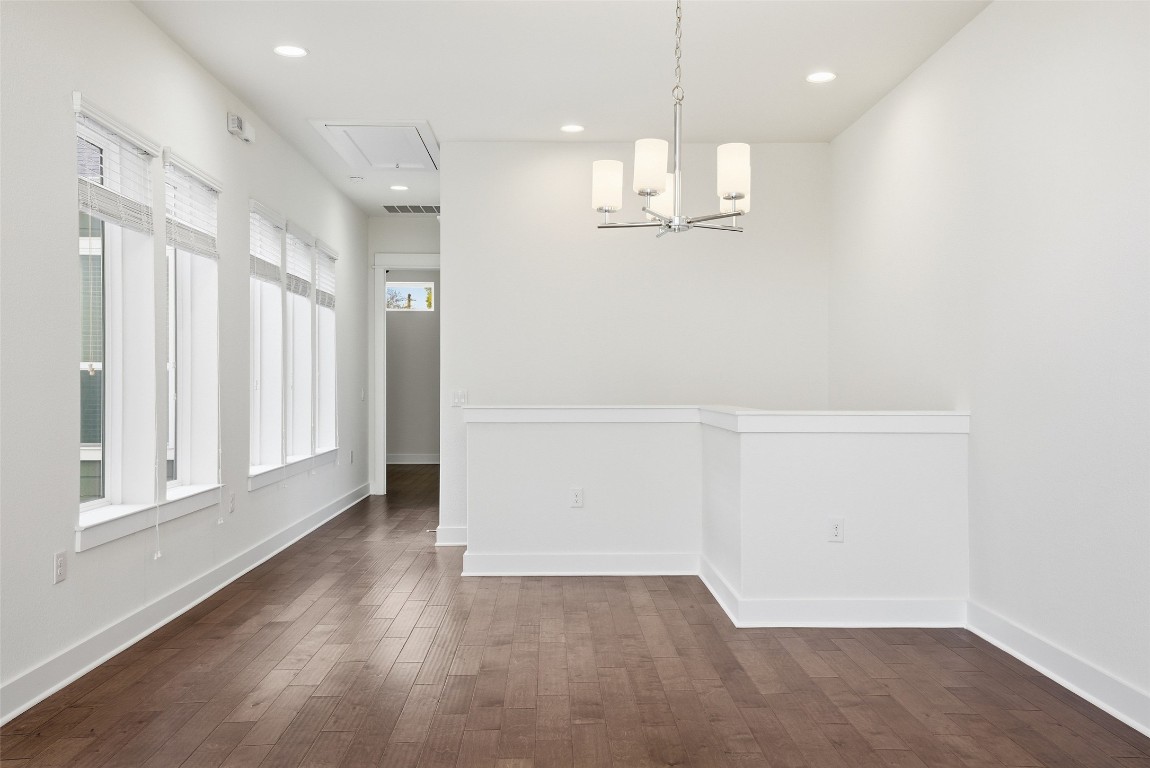 12604 Red Sparrow Street, Unit 14 Austin, TX 78729 - Photo 28 of 40 Unfurnished dining area with dark wood-type flooring, recessed lighting, a chandelier, and attic access