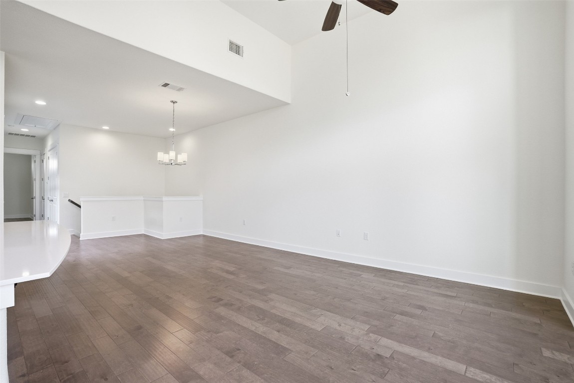 12604 Red Sparrow Street, Unit 14 Austin, TX 78729 - Photo 29 of 40 Unfurnished living room featuring dark wood finished floors, recessed lighting, ceiling fan, and attic access