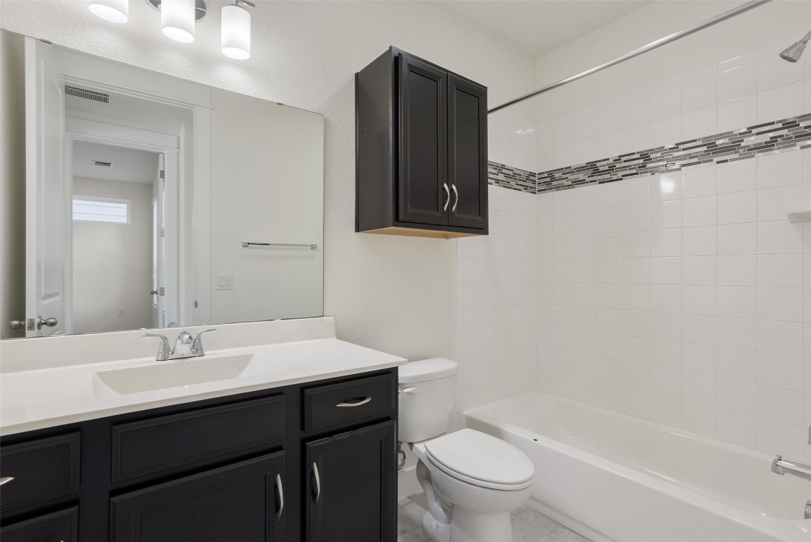 12604 Red Sparrow Street, Unit 14 Austin, TX 78729 - Photo 34 of 40 Full bath with shower / washtub combination and vanity