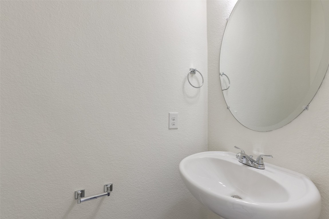 12604 Red Sparrow Street, Unit 14 Austin, TX 78729 - Photo 36 of 40 Bathroom featuring a textured wall and a sink