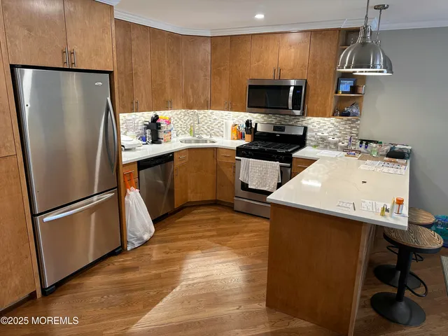 a kitchen with a refrigerator and a stove top oven