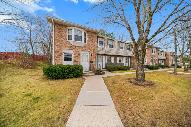 a view of a brick house with a yard