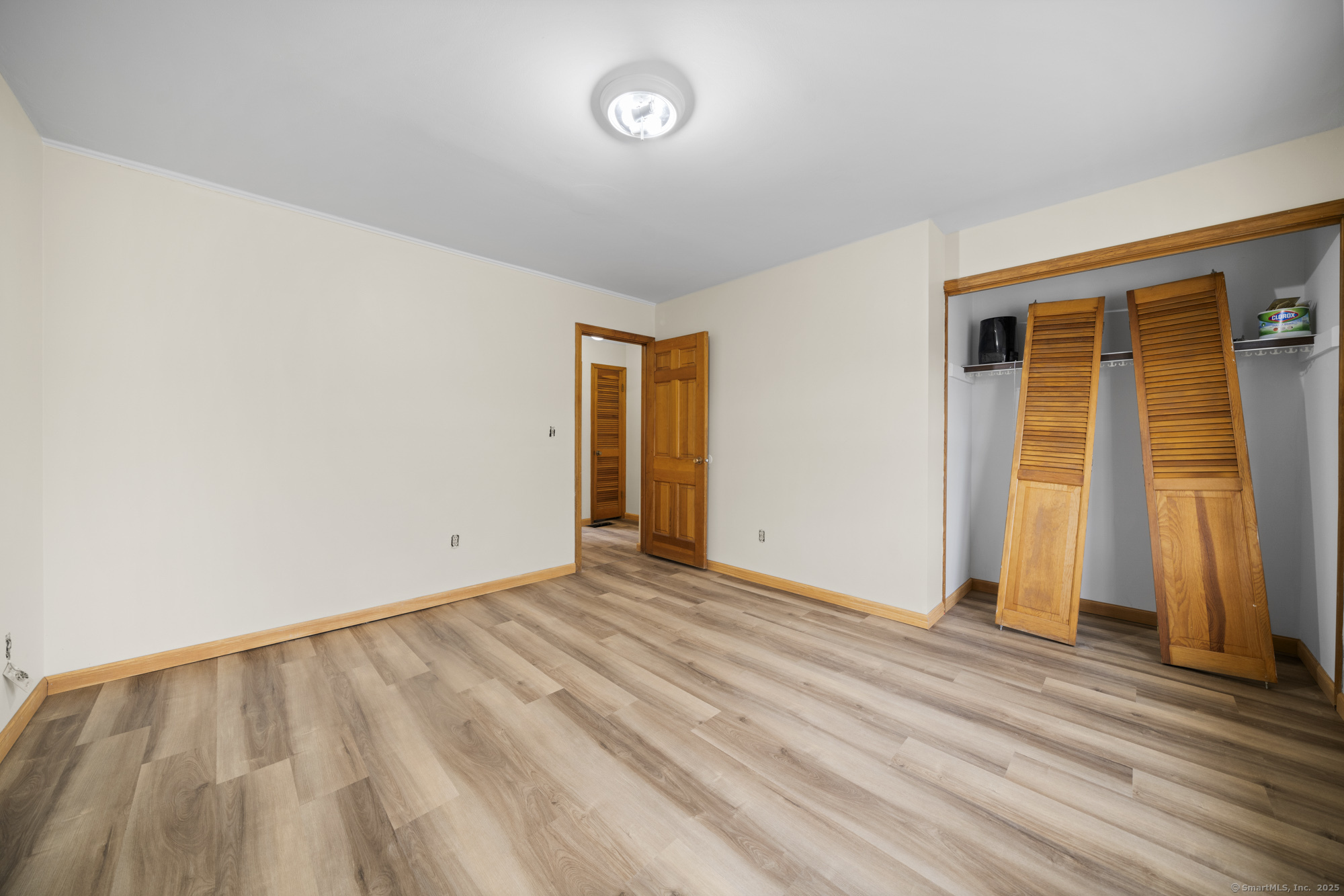 161 Kinney Street Torrington, CT 06790 - Photo 15 of 19 a view of an empty room with wooden floor and a window