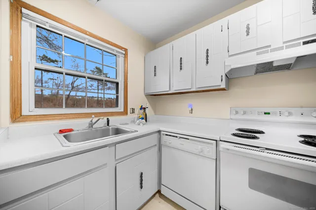 a kitchen with a refrigerator and white stove