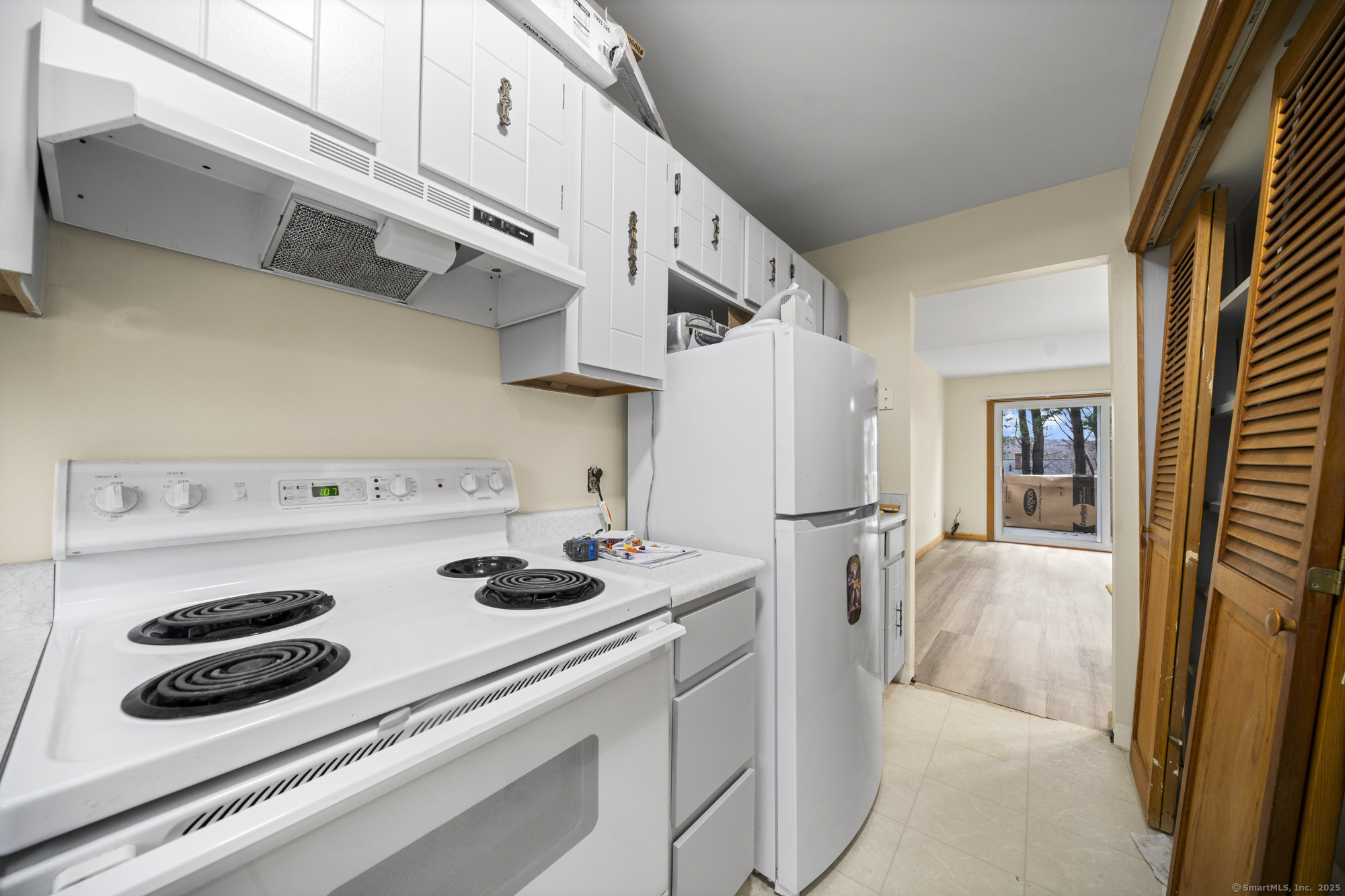 161 Kinney Street Torrington, CT 06790 - Photo 7 of 19 a kitchen with a refrigerator and white stove