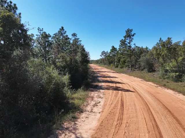 a view of a lake with a house and a yard