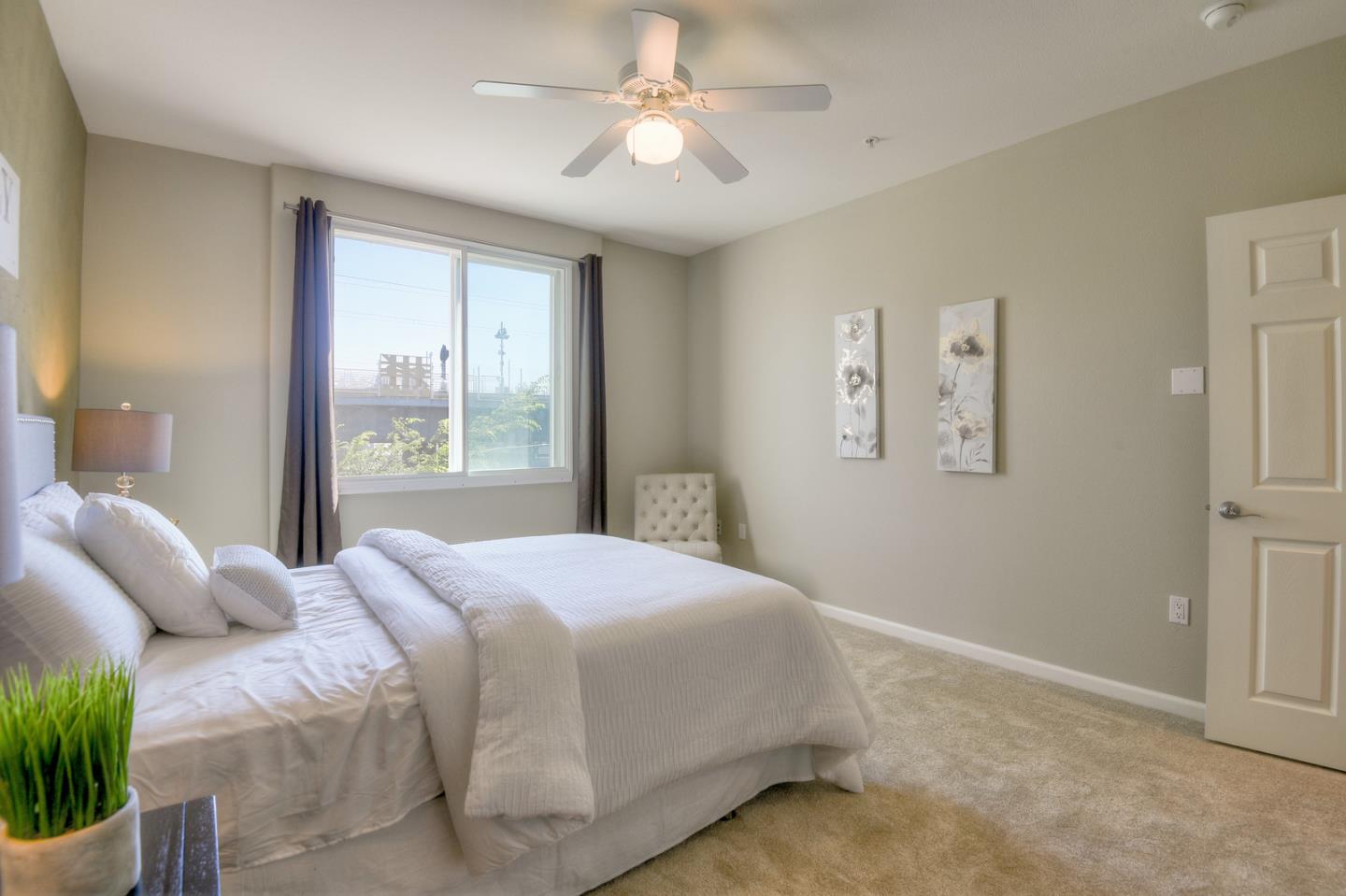 1101 South Main Street, Unit 316 Milpitas, CA 95035 - Photo 19 of 30 a bedroom with a large bed and a window