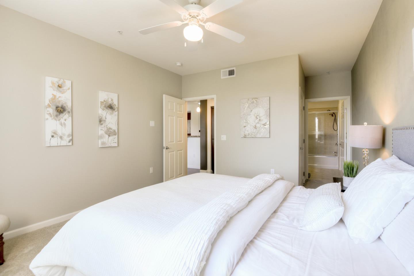 1101 South Main Street, Unit 316 Milpitas, CA 95035 - Photo 20 of 30 a bedroom with a large bed and a chandelier