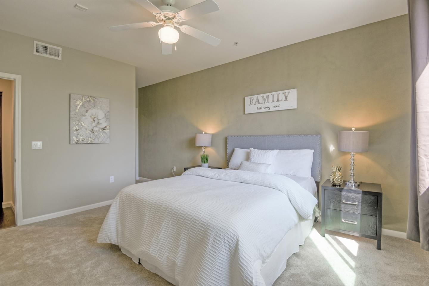 1101 South Main Street, Unit 316 Milpitas, CA 95035 - Photo 21 of 30 a bedroom with a bed and a lamp