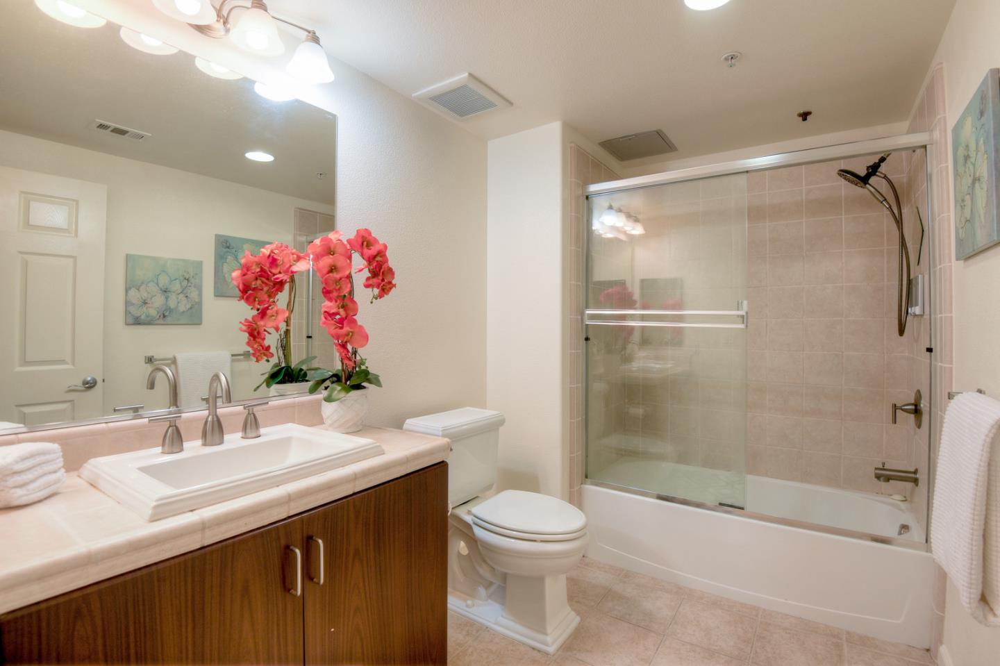 1101 South Main Street, Unit 316 Milpitas, CA 95035 - Photo 23 of 30 a bathroom with a sink vanity mirror and toilet