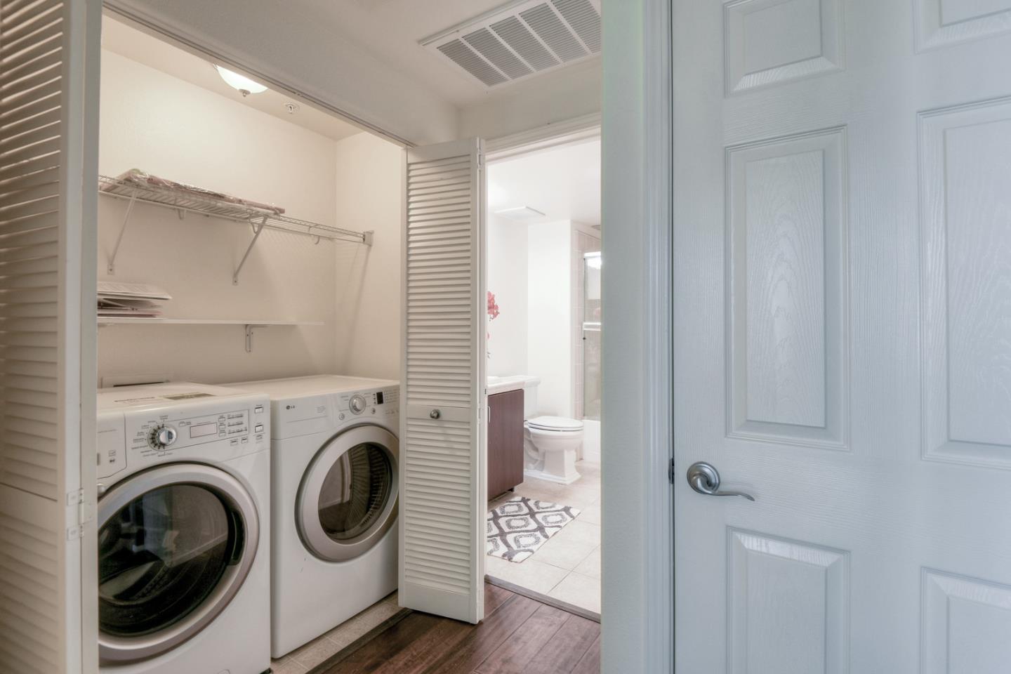 1101 South Main Street, Unit 316 Milpitas, CA 95035 - Photo 24 of 30 a view of a hallway with washer and dryer