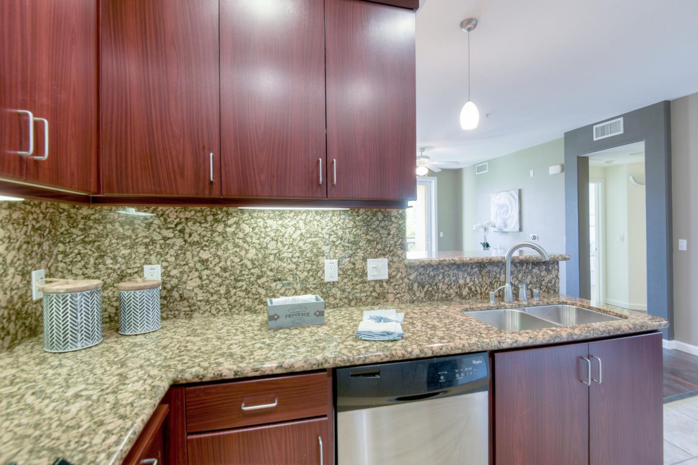1101 South Main Street, Unit 316 Milpitas, CA 95035 - Photo 8 of 30 a kitchen with granite countertop wood cabinets and sink