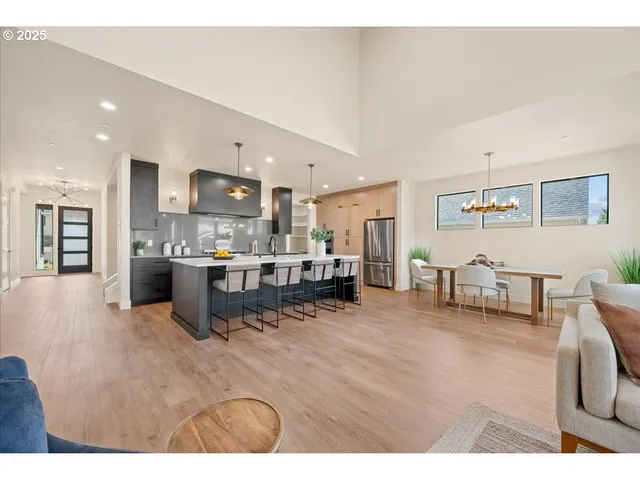 a kitchen with a dining table chairs and white cabinets