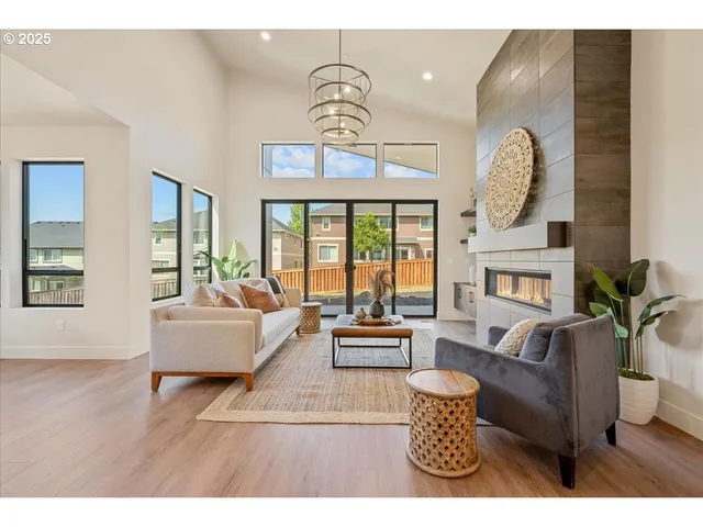 a living room with furniture a chandelier and a fireplace