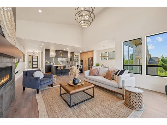 a living room with furniture a fireplace and kitchen view