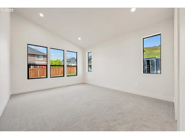a view of empty room with kitchen