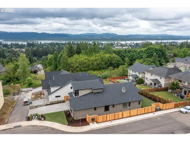 an aerial view of residential houses with outdoor space and city view