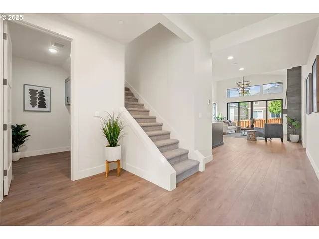 a living room with kitchen island furniture and a chandelier